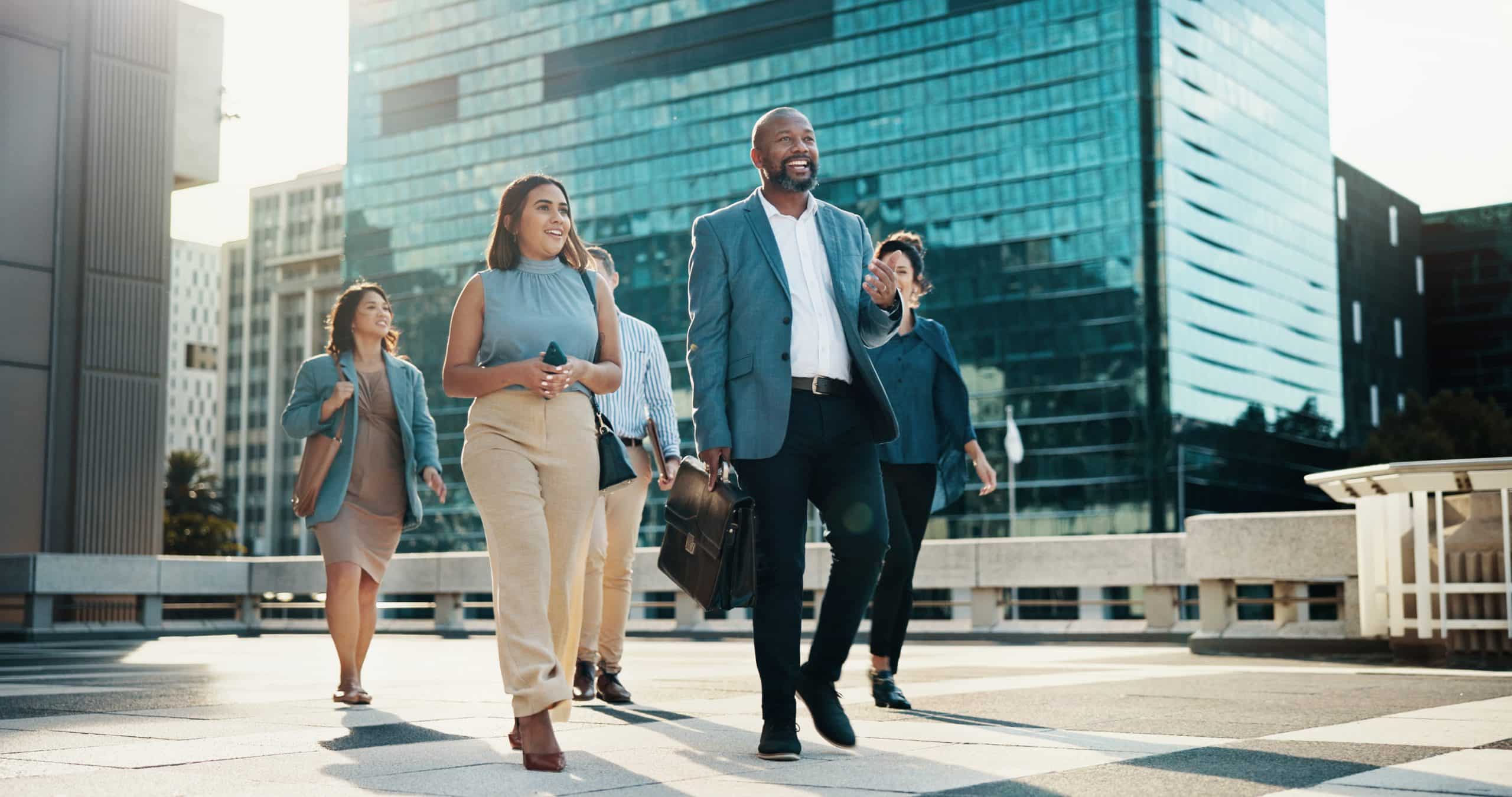 Professional, walking and happy business people in city on morning commute, travel and journey. Corporate, team of men and women in urban town for collaboration, meeting and discussion career